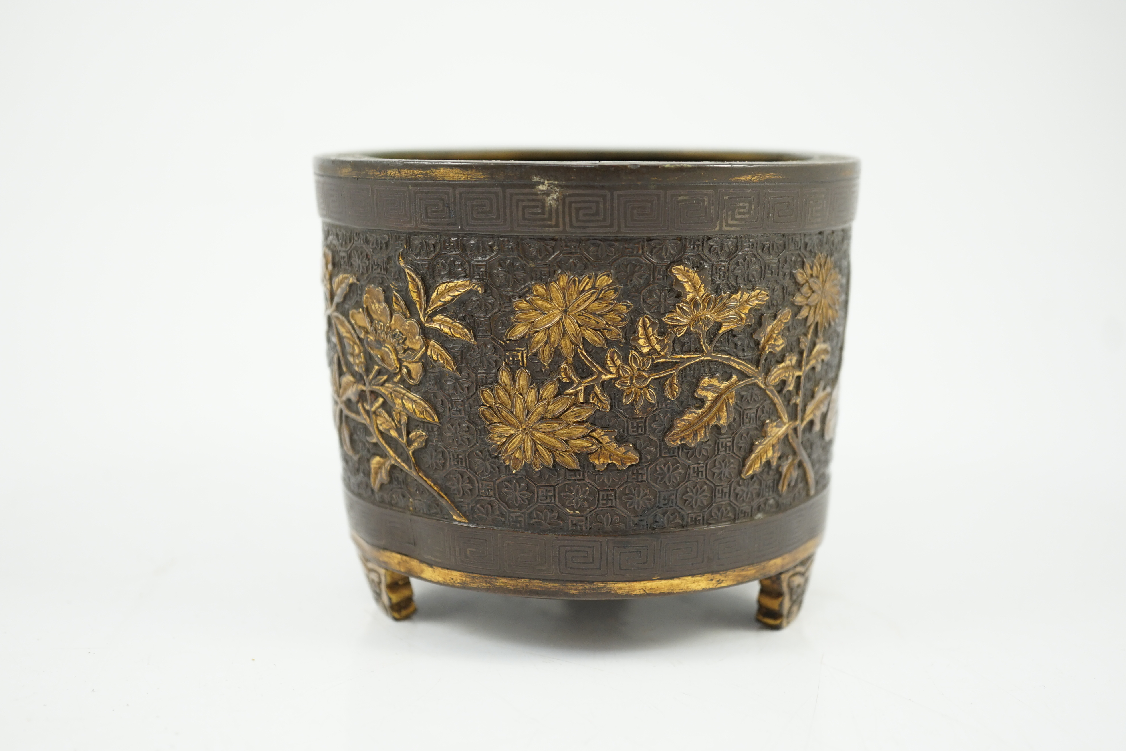 A Chinese parcel-gilt and silver inlaid bronze tripod censer, Yunjian Hu Wenming mark, 16th/17th century, small dents and three rim splits